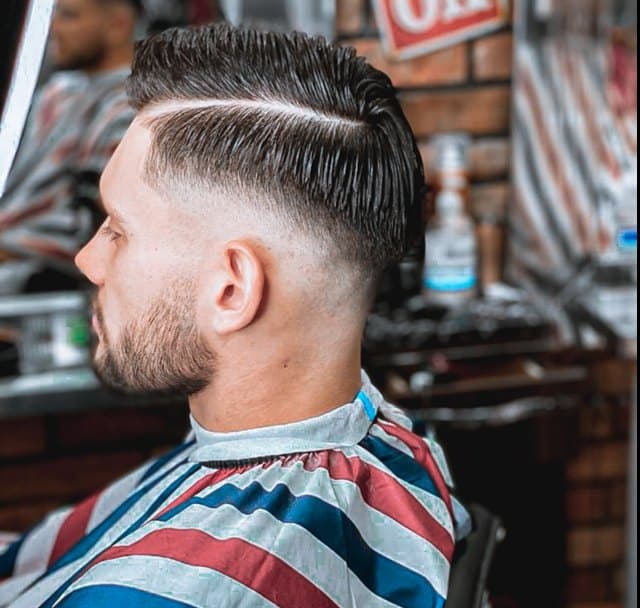 A finished side parting with a low fade