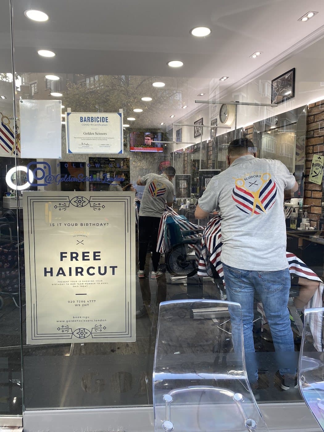 The team working, seen through the shopfront glass